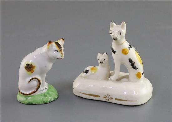 A Staffordshire porcelain seated cat and kitten group and a similar figure of a cat, c.1835-50, H. 7.3cm and 5.8cm, latter repaired